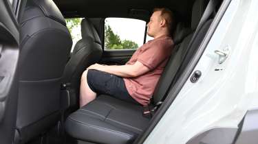 Auto Express news reporter Ellis Hyde sitting in the Toyota Yaris Cross's back seat